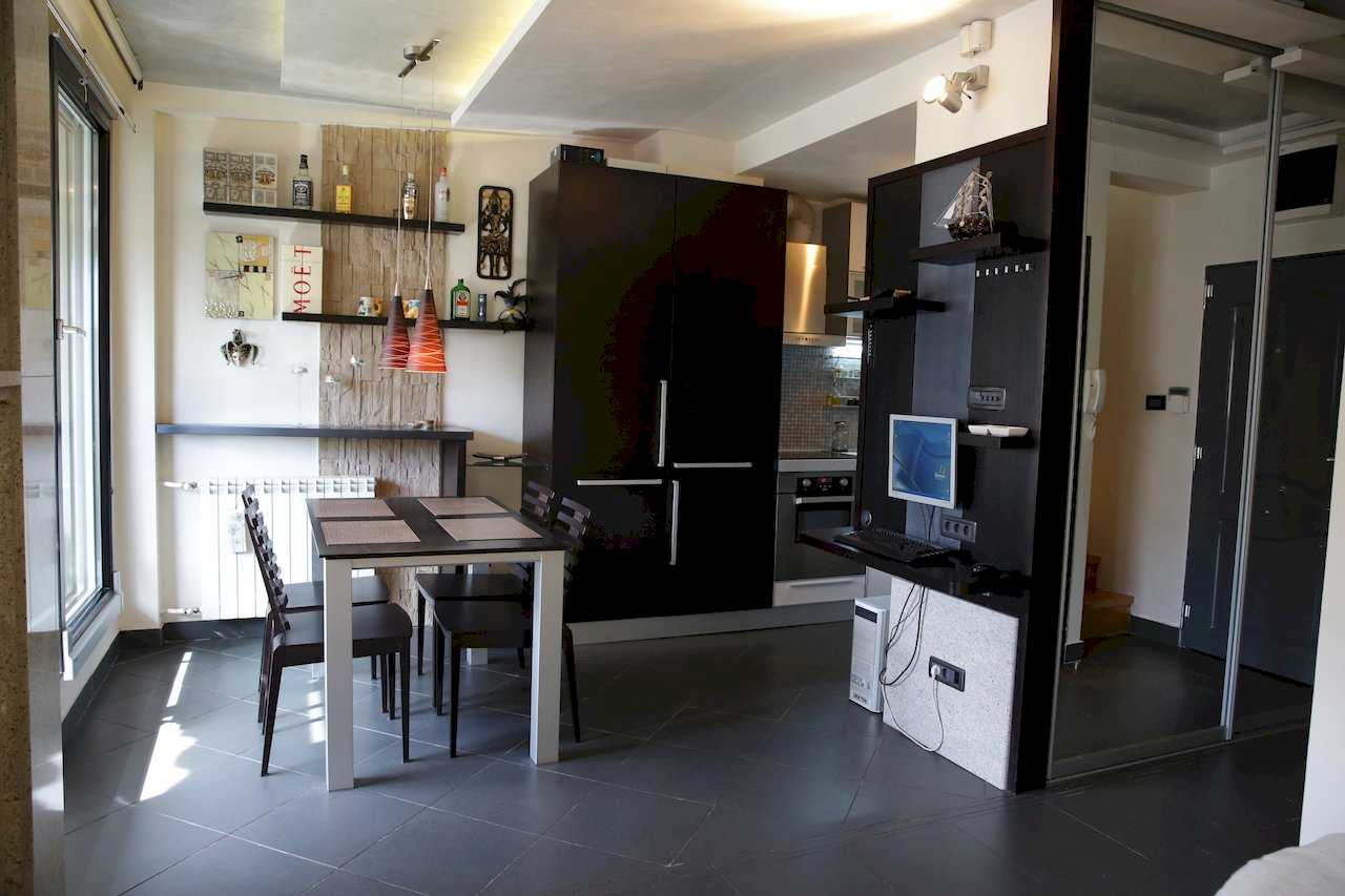 Dining table, large fridge and workspace with a computer – Apartment Arena – City Break Apartments