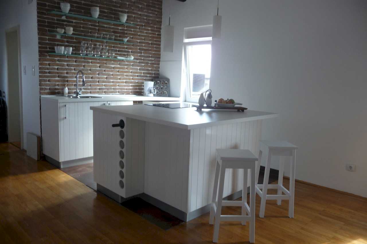 Kuhinja sa belim ostrvom i barskim stolicama, detalj prostora – Apartman Belgrade Sky – City Break Apartments