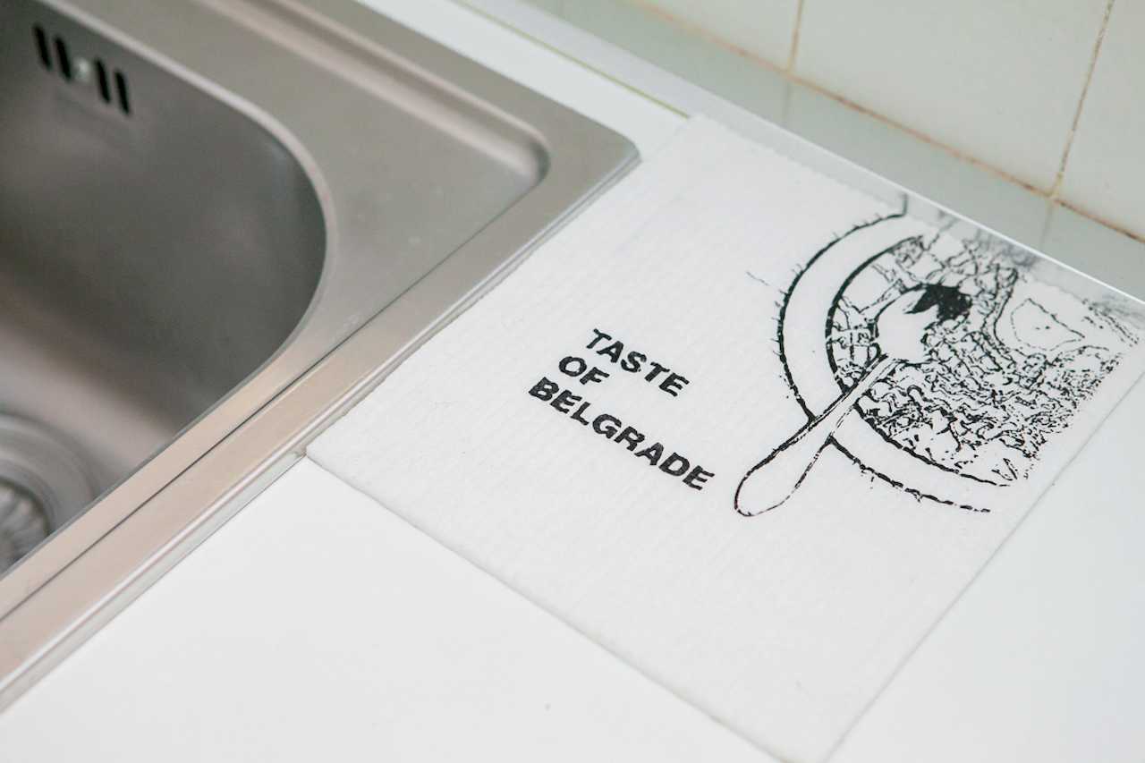 Apartment Downtown (Skadarlija, Belgrade) – counter detail by sink with "Taste of Belgrade" sign