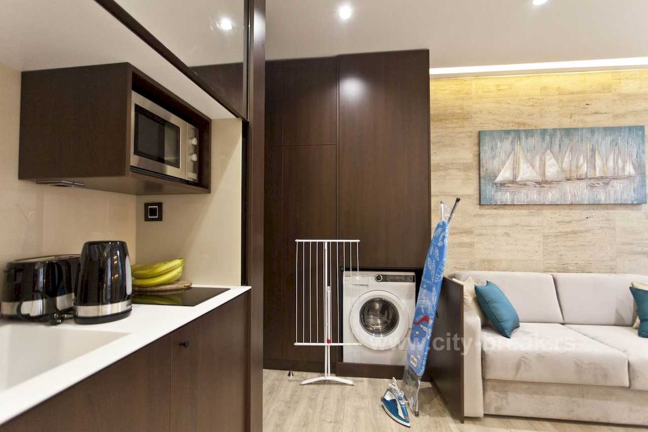 Apartman Obilić (Obilićev venac, Beograd) – detalj kuhinje sa veš mašinom, daskom za peglanje i parnom peglom